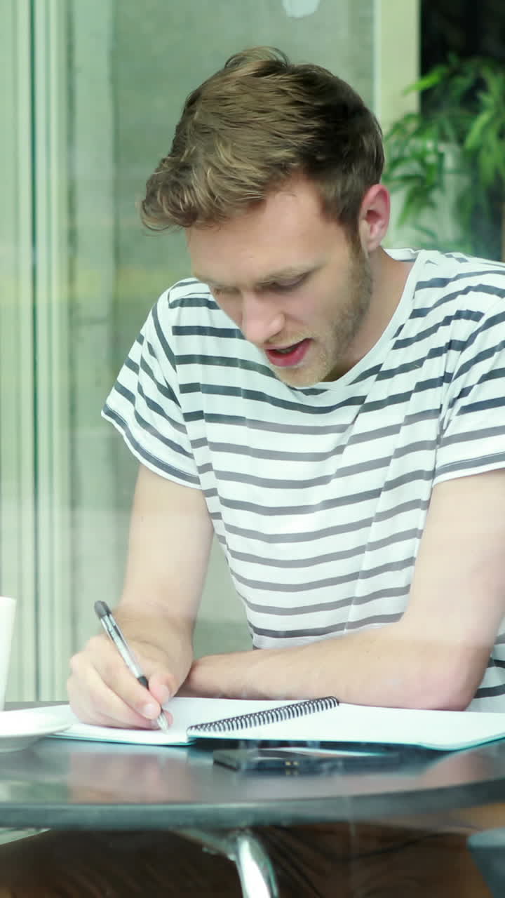Smiling student with coffee writing