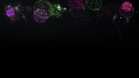 Animation-of-colourful-christmas-and-new-year-fireworks-exploding-in-night-sky,-with-copy-space