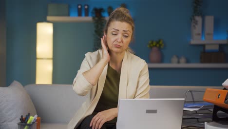 Home-office-worker-woman-scratches-her-ears-looking-at-camera.