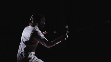 a fencer in action, wearing a white uniform and a mask, with a sword in hand, on a black background.