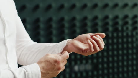 Man-Buttons-Sleeve-White-Shirt-On-A-Dark-Background-Indoors