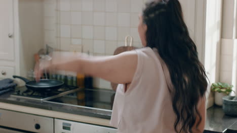 happy overweight teenage girl dancing in kitchen having fun celebrating weekend performing funny dance moves at home enjoying weekend celebration