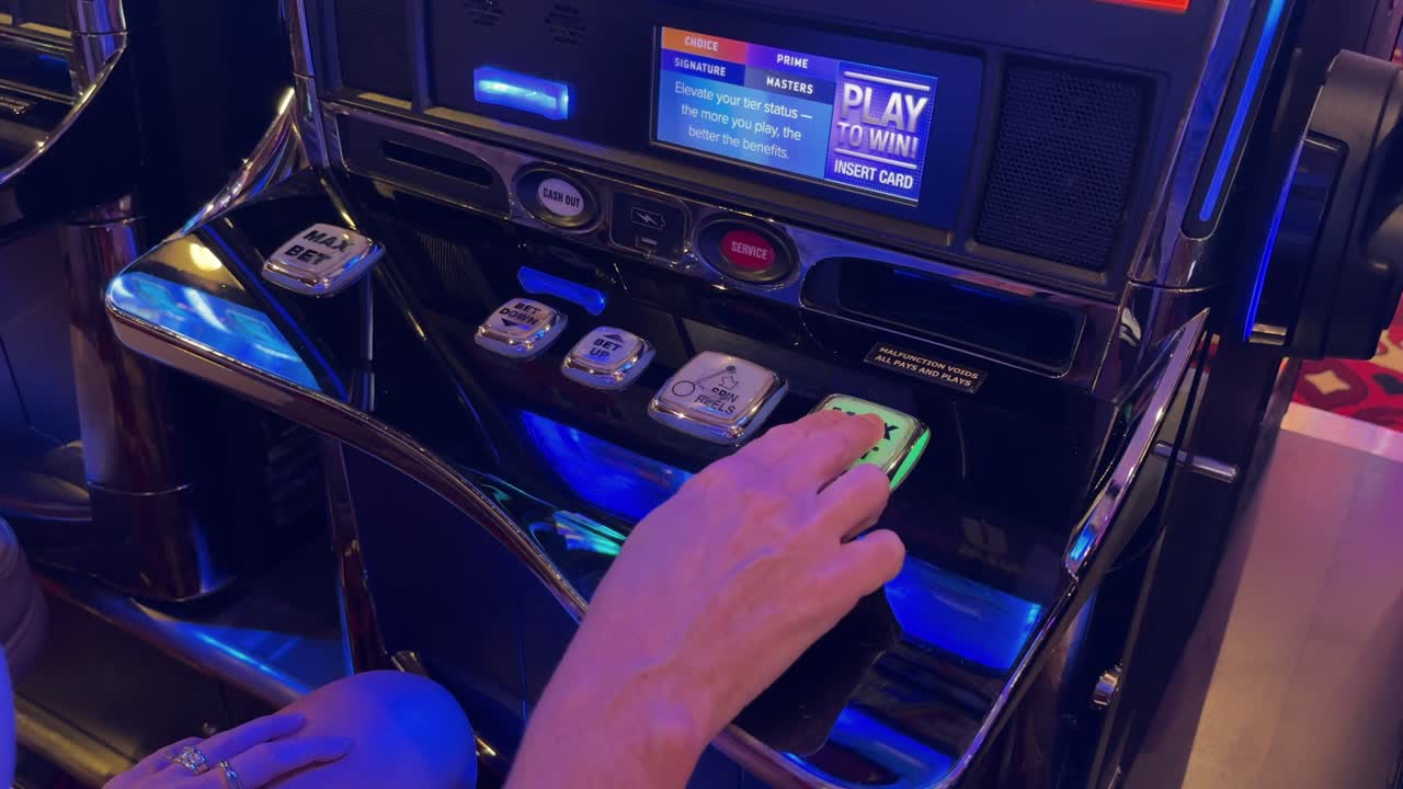 Close up, white female hand pressing max bet button on casino slot machine, 4k