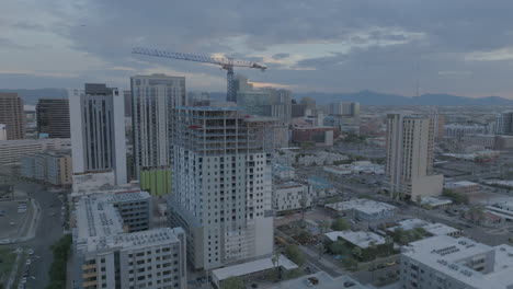 rotating drone shot of hotel construction at twilight