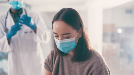 woman receiving vaccine and taking selfie with doctor