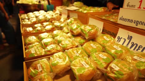 4K-Closeup-shot-of-Freshly-cooked-buns-for-sale-in-Chinese-walking-street,-night-market-in-Bangkok,-Thailand