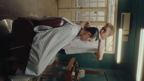 male client getting new haircut in the barbershop