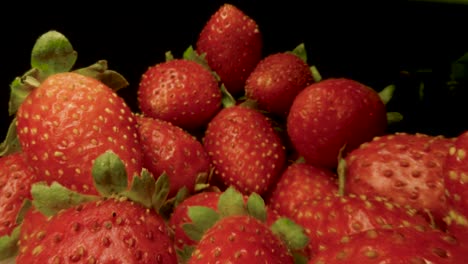 macro slide ripe juicy strawberry. healthy organic food. the camera moves through a heap of strawberries. dolly shot using a probe lens. red berries. close-up. type d.