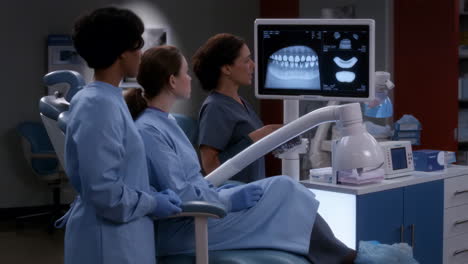 healthcare professionals examining dental x-rays in a clinic