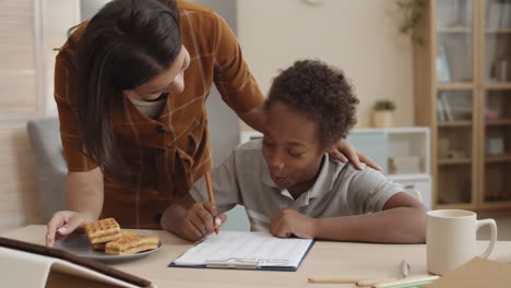 mother helping child with homework