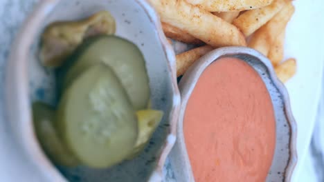 french fries with sauce and pickle