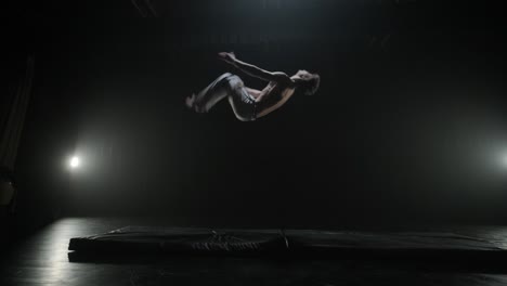 capoeira fighters performing dynamic moves on stage. martial arts, dance, and acrobatics in action. bare-chested athletes showcasing strength, flexibility, and technique under spotlights