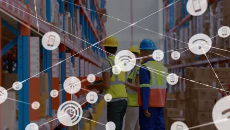 Animation-of-network-of-connections-with-icons-over-men-working-in-warehouse