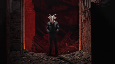 person with goat mask in abandoned building