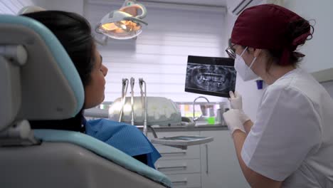 Pensive-doctor-looking-at-X-ray-shot