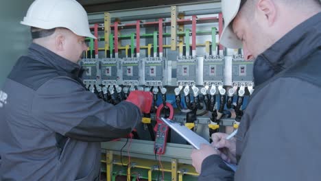 checking the operating voltage levels of the solar panel switchgear compartment