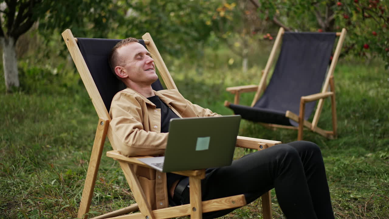 Mid aged freelancing specialist finishing online chat on his laptop. Man says goodbye and leans back relaxing in his chair. Freelancer opens his eyes and sees something bad happens on the screen.