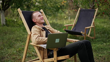 mid aged freelancing specialist finishing online chat on his laptop. man says goodbye and leans back relaxing in his chair. freelancer opens his eyes and sees something bad happens on the screen.