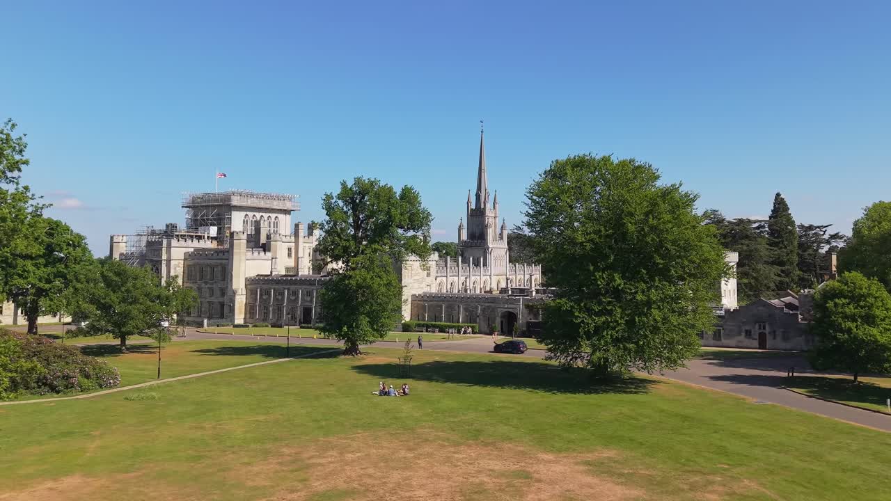Cinematic approach to Ashridge House’s entrance in England, with a car arriving, capturing the elegance of the historic estate