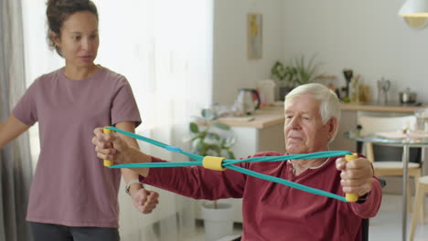 eldelrly man in wheelchair exercising with resistance band