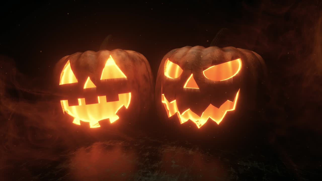 Halloween pumpkins are burning, glowing and sparkling from the inside on a black background with smoke. Ultra HD 4k seamless loop animation for festive horror decoration.