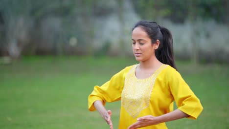 Indian-girl-doing-breathe-in-breathe-out-yoga-exercise