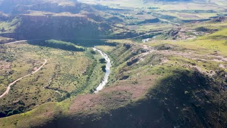 panning drone shot of mountains and river below