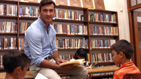 cute pupils with teacher in library