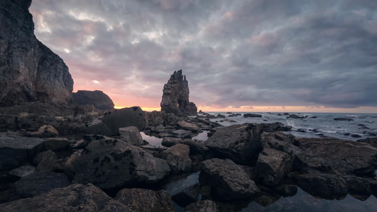 Dramatic Coastal Sunset with Rock Formations
