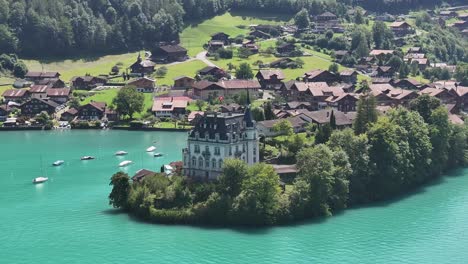 iseltwald village and elegant mansion on turquoise lake brienz, bernese oberland