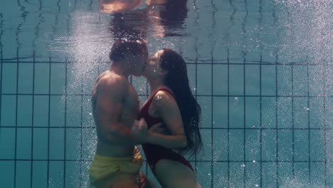Unterwasserpaar-Küsst-Sich-Im-Schwimmbad-Junge-Verliebte-Menschen-Genießen-Einen-Romantischen-Kuss-Leidenschaftliche-Liebhaber-Im-Wasser-Schwimmend-Mit-Blasen-In-Spielerischer-Intimität