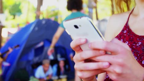 woman using mobile phone in park 4k