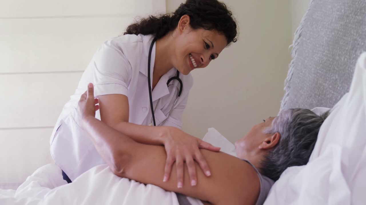 une femme médecin réconfortant une femme âgée sur le lit 4k