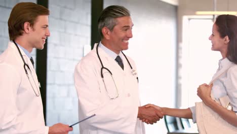 smiling male doctor shaking hands