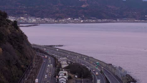 Epic-slow-tilt-up-over-highway-and-Mount-Fuji-during-beautiful-pink-sunset