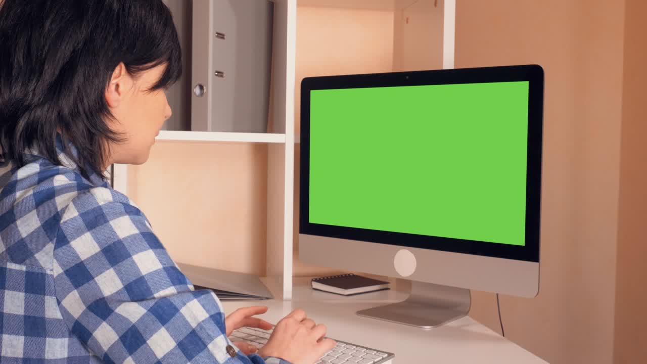 brunette looking on monitor pc at work