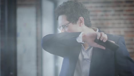 video compuesto digital de puntos de luz contra hombre caucásico estornudando en su codo en la oficina