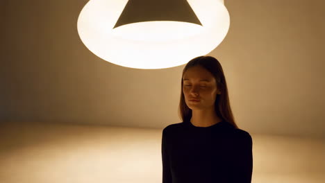 portrait of a woman in a warmly lit minimalist space