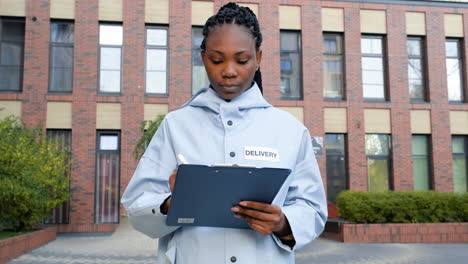 Young-woman-with-a-clipboard-outdoors