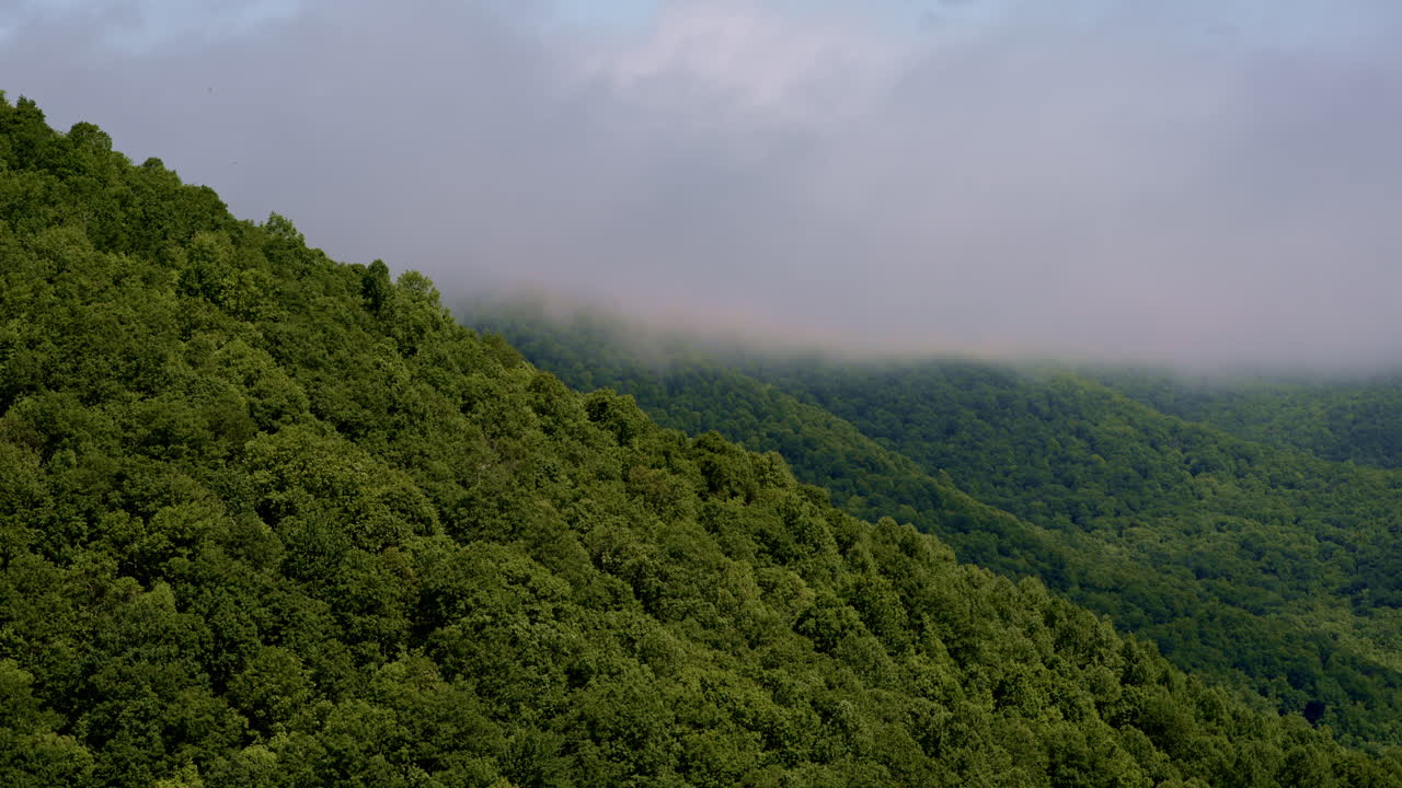 A moody drone view of the expansive, rain-soaked Smoky Mountains