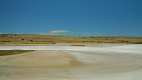 drone footage of salt flats with island