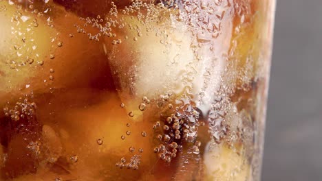 vaso de coca cola gaseosa con burbujas y cubitos de hielo - primer plano 4k