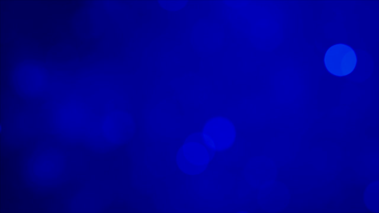 abstracción de luces desfocalizadas brillantes sobre un fondo azul oscuro. resolución de 4k.