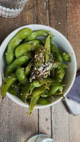 edamame being seasoned