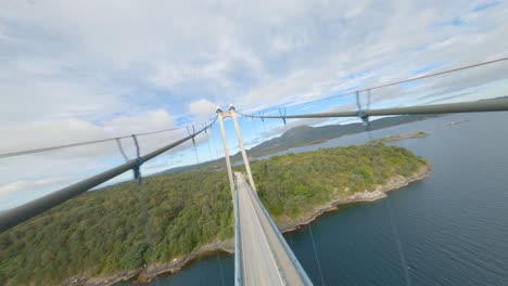 aerial flight over bømla suspension bridge with driving car in norway