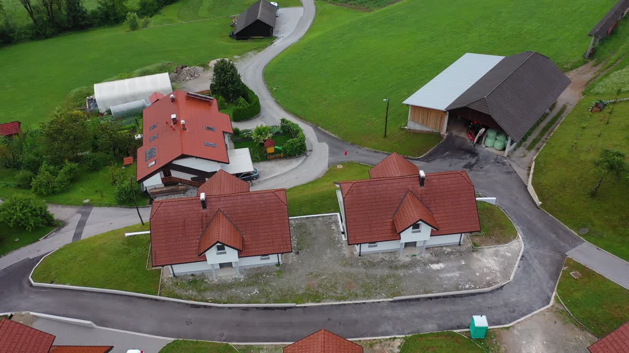Drone aerial ascending tilt down bird eye view of a small village with cluster of houses