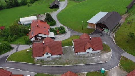drone aerial ascending tilt down bird eye view of a small village with cluster of houses