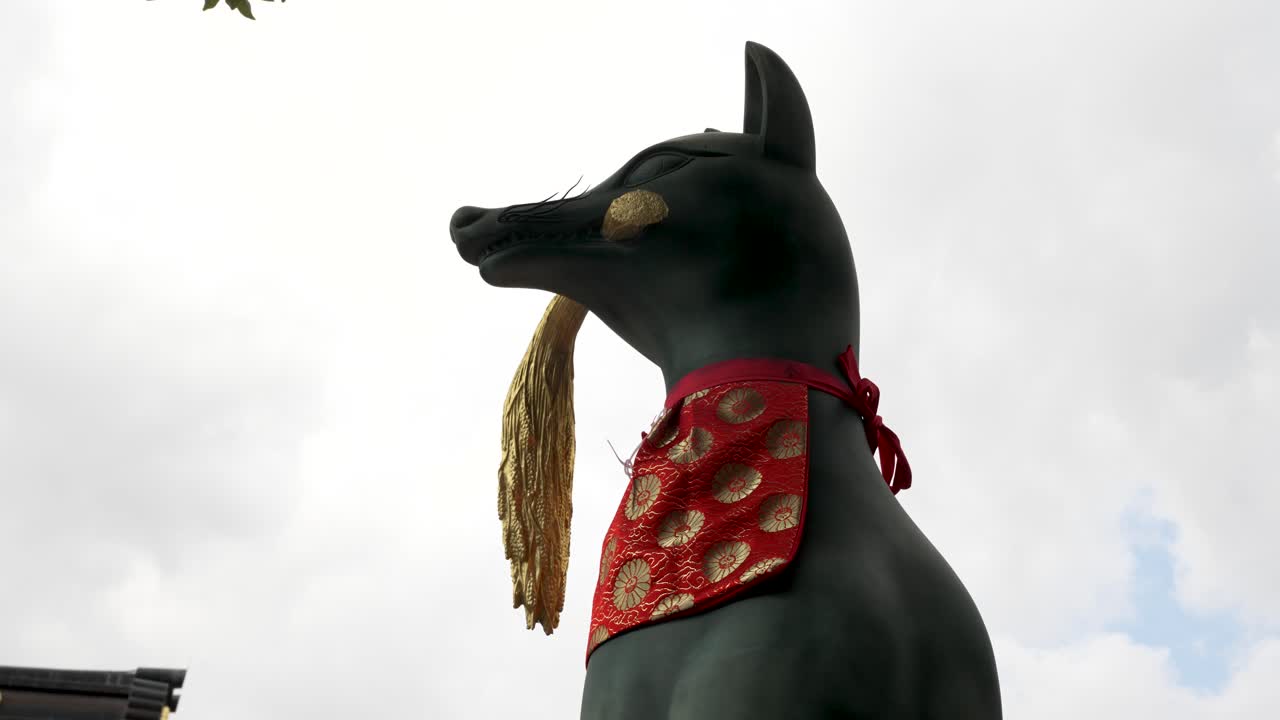 estatua de zorro inari con la cosecha de arroz dorado en la boca en fushimi inari-taisha