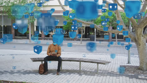 multiple digital icons floating against african american man wearing face mask using digital tablet