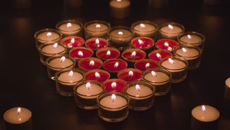 romantic red and white candles in the shape of a heart on black background 1